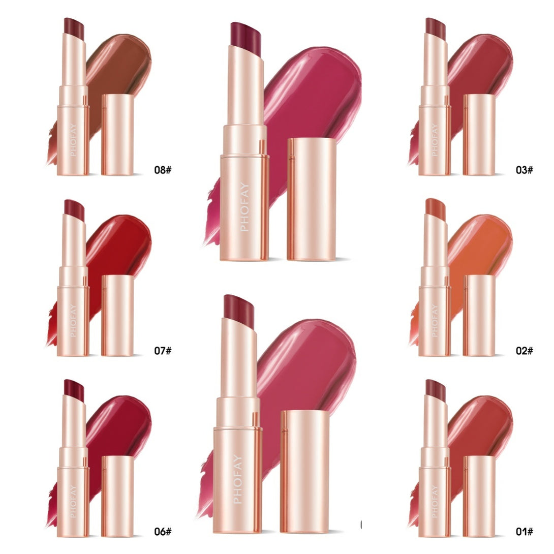 Set of lipsticks with rose gold cases on a white background