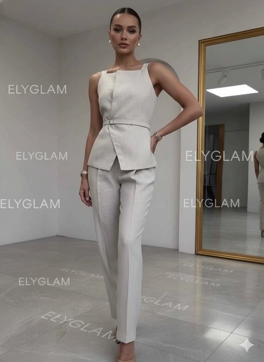 Woman in a white outfit standing in front of a mirror with 'ELYGLAM' branding.