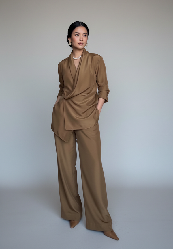 Woman wearing a brown outfit against a plain background