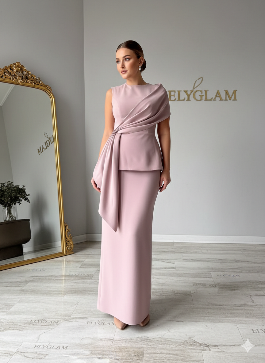 Woman wearing a pink dress standing in front of a mirror with 'Ely Glam' branding.