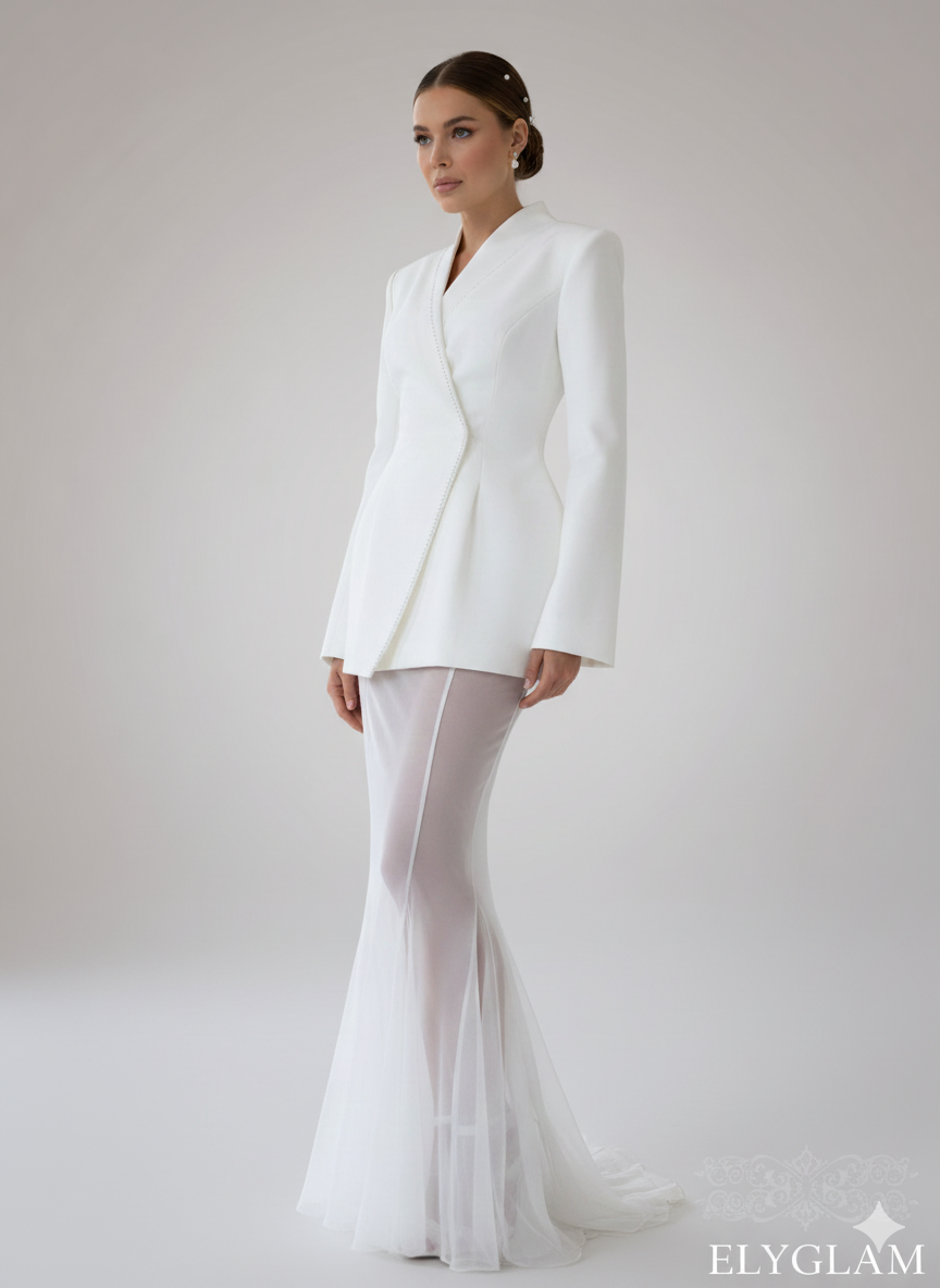 Woman wearing a white bridal suit with a plain background