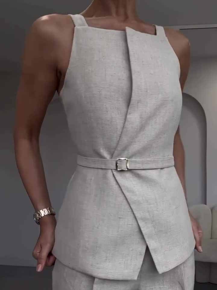 Gray sleeveless top with a belt worn by a person, standing against a neutral background.